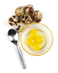 Raw quail eggs and spoon