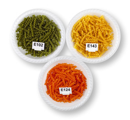 Artificially colored pasta in plates