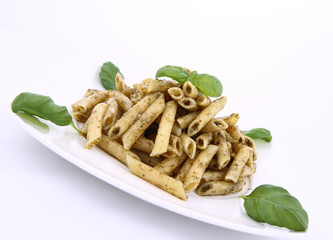 Penne with pesto decorated with basil