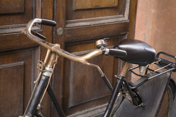 Old  Bicycle leaning on a Door  in Italy