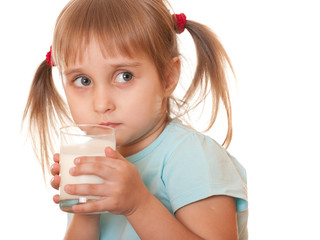 Thoughtful girl holding glass of milk