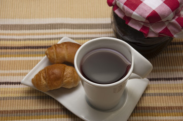 Tea, mini croissants and jam jar