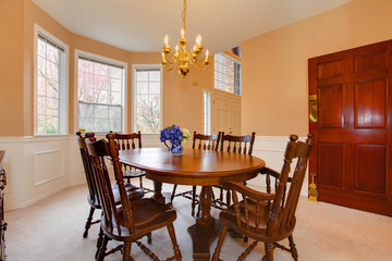 Classy creamy dining room with antique furniture