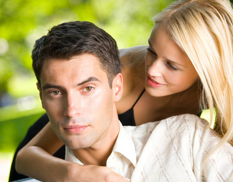 Young happy amorous embracing couple, outdoors