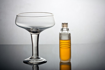 A glass and a perfume bottle