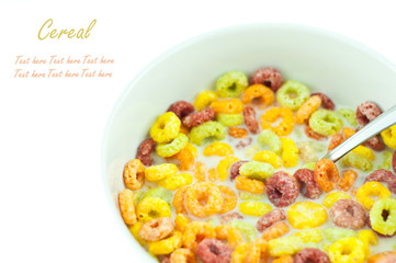 Bowl and spoon with corn flakes on the white background