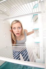 Fototapeta na wymiar Teenager and empty fridge