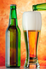 Bottle glass of beer on a yellow background
