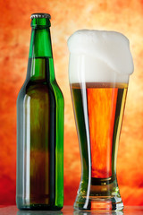 Bottle glass of beer on a yellow background