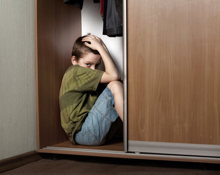 Sad boy, hiding in the closet