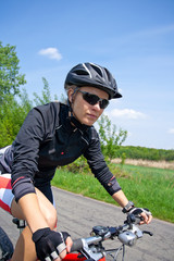 Woman riding on bicycle on summer day