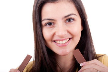 Beautiful teenage girl eating chocolate isolated