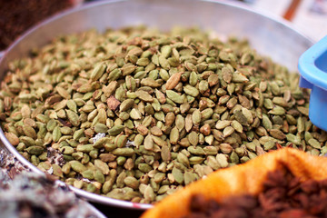 Green cardamom in metallic bowl