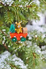 Vintage Christmas decoration on a fir tree covered with snow