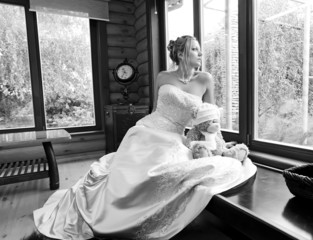 Gorgeous young bride looking out of the window