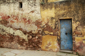 Grunge background : old damaged wall and door