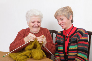 Two generations senior and mature womans knitting