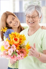 Elderly woman and daughter smiling happily