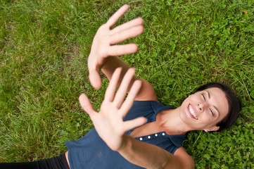 Happiness - woman lying in grass