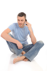 Obraz premium casual young man speaking on the mobile phone. isolated