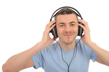 young handsome man listening to music in headphones. isolated