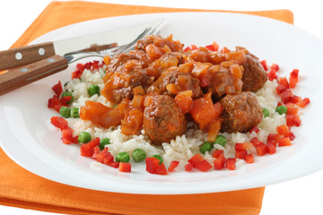 meatballs with boiled rice with peas