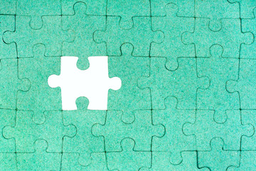 Green puzzle with missing piece