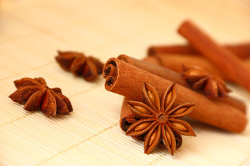 Anise star and several cinnamon sticks on bamboo background