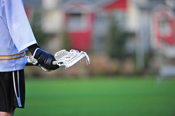 Boys lacrosse player holding stick