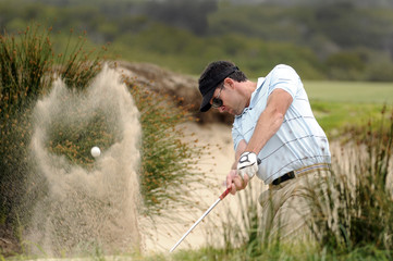 Golfer playing a bunker shot