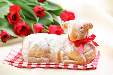 Easter lamb cake and red tulips on white background © Elena Schweitzer