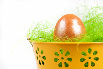 Yellow metallic bucket with colorful Easter eggs