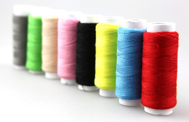Set of colorful spools of thread isolated on white background