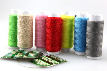 Set of colorful spools of thread isolated on white background