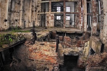 Fototapeta premium Abandoned Ruins of a former Factory. Creepy industrial building
