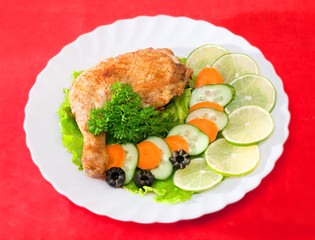 Fried chicken leg with lemon and cucumber