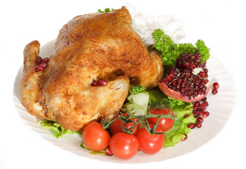 Roast chicken with tomatoes and a pomegranate