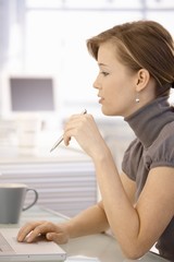 Portrait of attractive businesswoman at desk