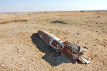 Rusty aircraft bomb on the ground.