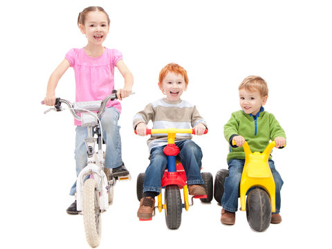 Children Riding Bikes And Kids Trikes