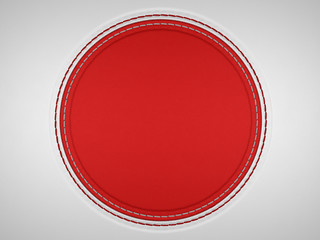 Red and grey stitched circle shape on leather