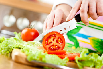 Woman's hands cutting vegetables