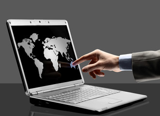 Black laptop with world outlines on the screen