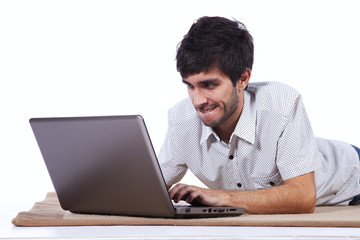 Happy young man surfing the internet