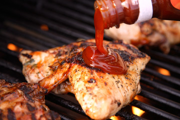 Pouring Barbeques Sauce on Chicken
