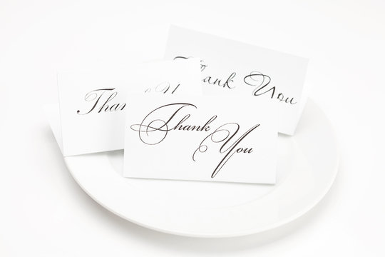 plate with card signed thank you isolated on white