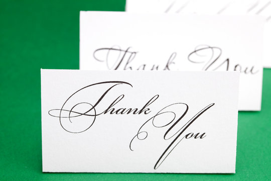 card signed thank you on green background