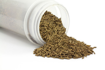 Caraway seeds spilling from container