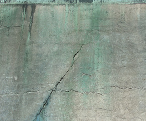 Obraz premium cracked worn stone and bronze surface from a monument