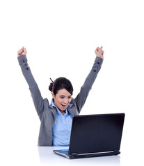 Young woman in office jubilates at desk